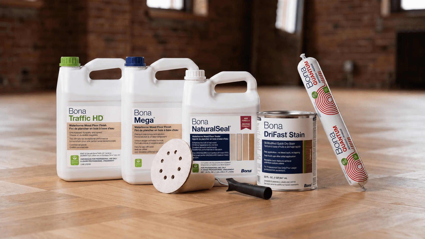 Bona flooring products on a wooden floor with a brick wall background